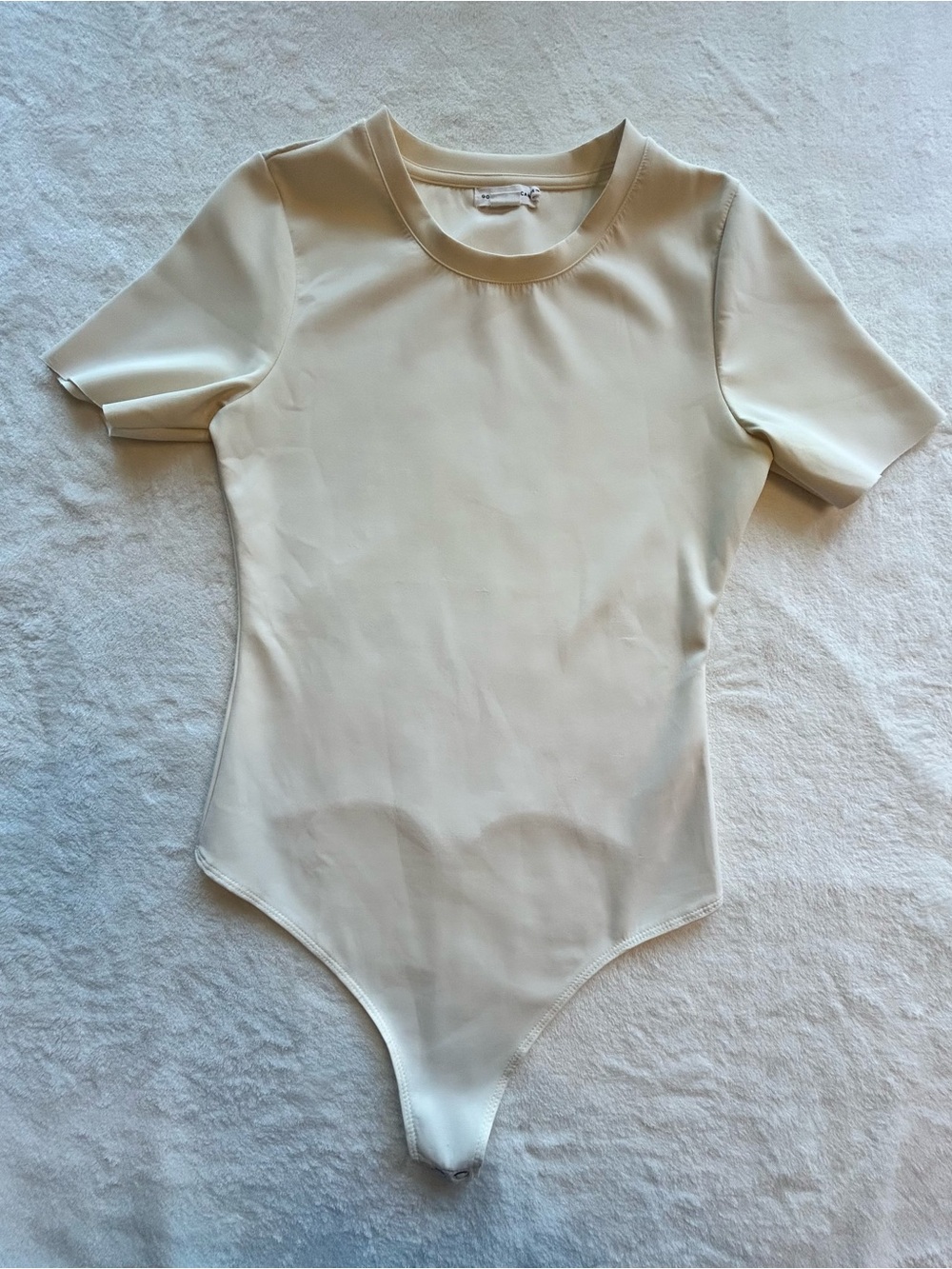 Sleek Y2K Minimalist Cream Short Sleeve Bodysuit by Good American